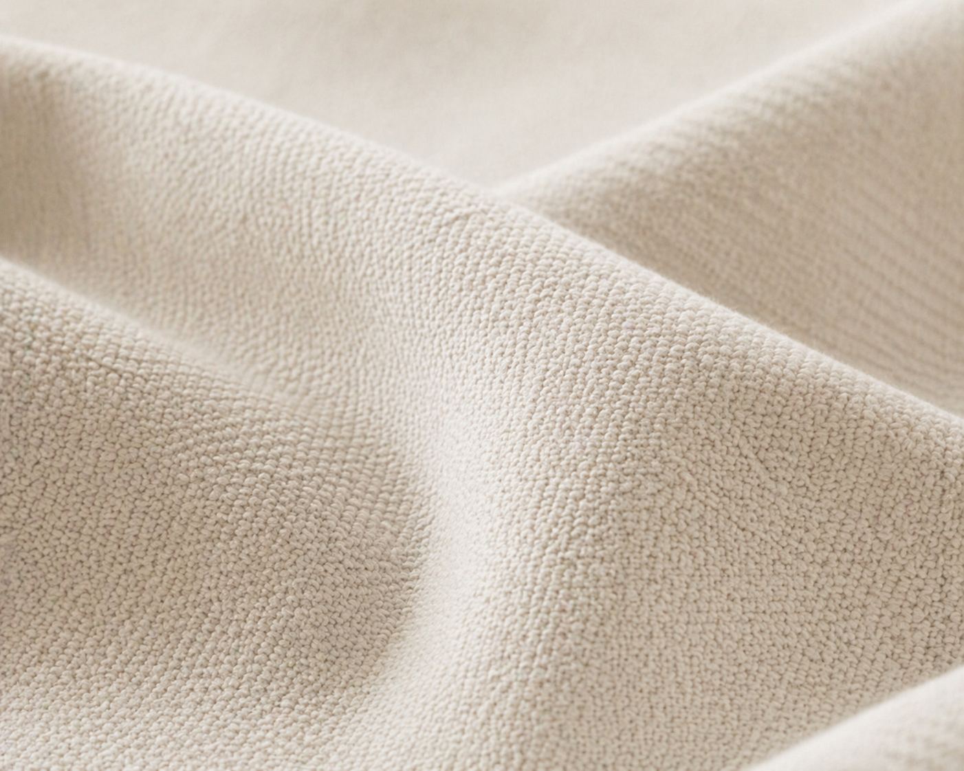 Close-up of brushed merino wool — the soft outer fabric of the Held by Miru long-distance gift cushion.